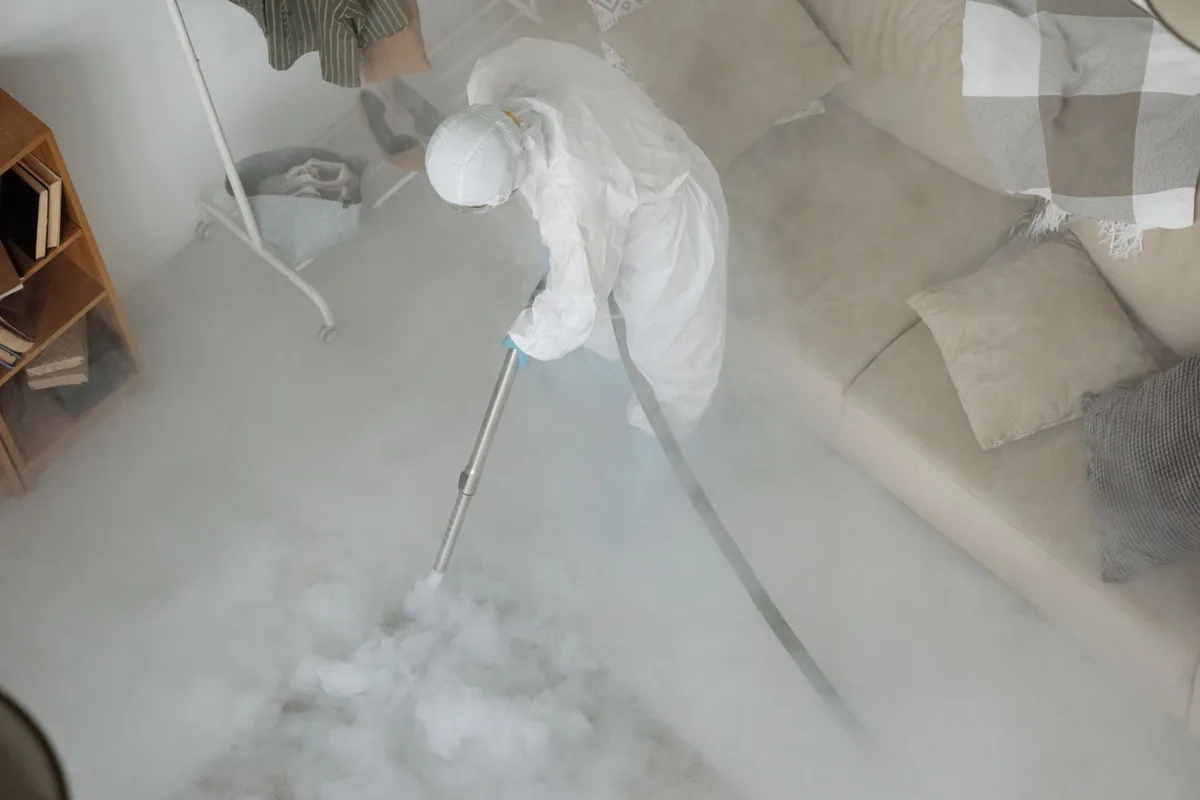 Biohazard cleanup technician in protective equipment, Iola, KS